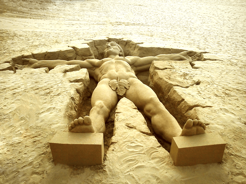 Beach sand sculpting. Anatomically correct sand sculpture.
