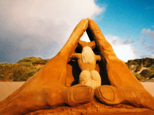 Mermaid between two larger than life hands.