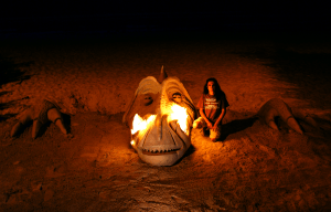 Huge dragon head breathing fire on the beach.